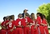 3812540-group-of-children-soccer-players-embracing-standing-in-front-of-coach-back-view
